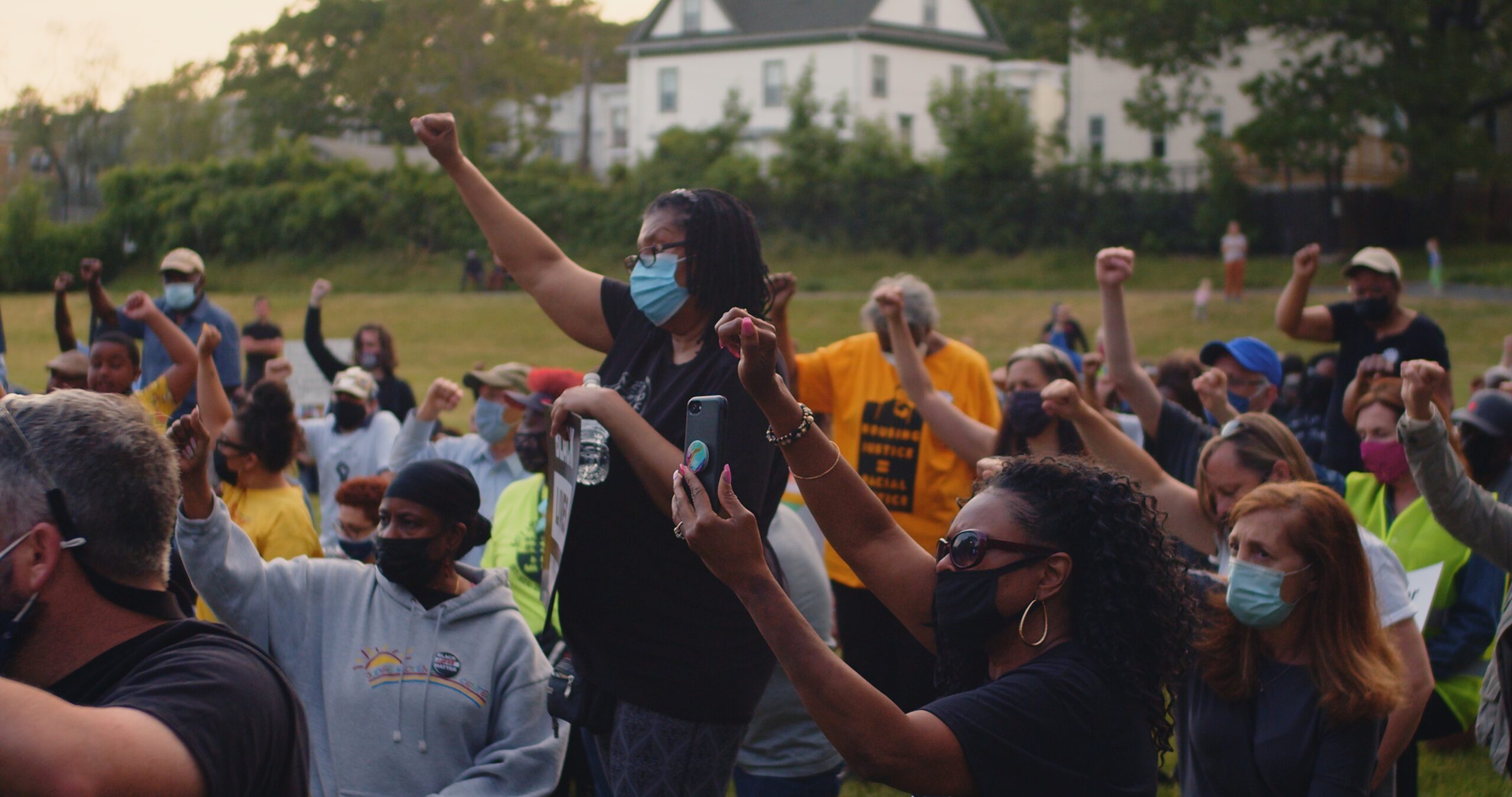 People raising their fist in solidarity for Black Lives.