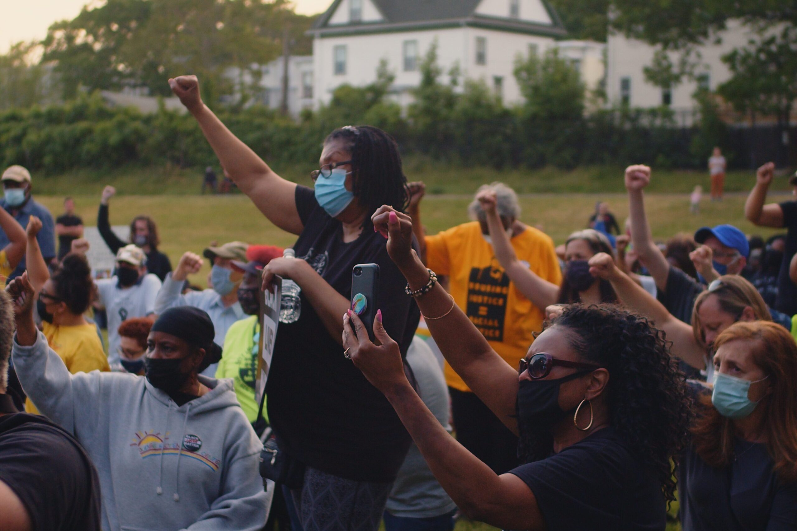 People raising their fist in solidarity for Black Lives.